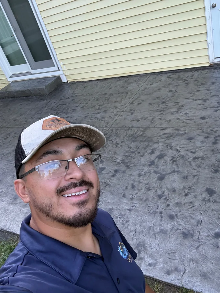 Luis, owner and operator of Capital Pro Pressure Washing, at a completed stamped concrete project